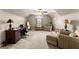 The bedroom features neutral carpeting, a ceiling fan, and an accent chair by the window at 4955 Winding Rose Dr, Suwanee, GA 30024