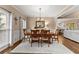 Elegant dining room featuring a chandelier, large windows, and hardwood floors for sophisticated dining at 4955 Winding Rose Dr, Suwanee, GA 30024