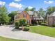 Beautiful brick home with a long driveway and mature trees adding to the property's privacy at 4955 Winding Rose Dr, Suwanee, GA 30024