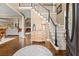 Inviting foyer with hardwood floors, a staircase, and a view into the living room with a fireplace at 4955 Winding Rose Dr, Suwanee, GA 30024