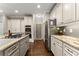 Spacious kitchen featuring stainless steel appliances, granite countertops, and ample storage at 4955 Winding Rose Dr, Suwanee, GA 30024