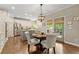 Cozy kitchen with wood floors, granite countertops, stainless appliances, and modern lighting fixtures at 4955 Winding Rose Dr, Suwanee, GA 30024