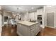 Open kitchen boasts stainless appliances, granite counters, and a large island for cooking at 4955 Winding Rose Dr, Suwanee, GA 30024