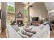 Inviting living room with a brick fireplace, soaring ceilings, and abundant natural light from large windows at 4955 Winding Rose Dr, Suwanee, GA 30024