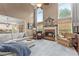 Bright living room with fireplace, soaring ceilings, and a view into the open kitchen at 4955 Winding Rose Dr, Suwanee, GA 30024