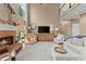Spacious living room featuring a cozy brick fireplace and elegant decor at 4955 Winding Rose Dr, Suwanee, GA 30024