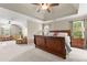Large main bedroom with trey ceilings and a seating area at 4955 Winding Rose Dr, Suwanee, GA 30024
