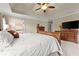 Bright main bedroom with natural light boasts a beautiful bed frame and dresser at 4955 Winding Rose Dr, Suwanee, GA 30024