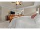 Bright main bedroom boasts a beautiful bed frame and dresser at 4955 Winding Rose Dr, Suwanee, GA 30024