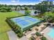 Aerial of tennis courts and a pool beside a lake with mature trees and a paved path, for outdoor activities at 4955 Winding Rose Dr, Suwanee, GA 30024