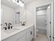 Bright bathroom features a double vanity with black hardware and a nearby shower and toilet at 910 Melody Ridge Ln, Buford, GA 30518