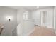 Hallway featuring a staircase, wood floors, and two doors, one slightly ajar at 910 Melody Ridge Ln, Buford, GA 30518