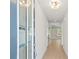 Bright and airy hallway with light hardwood floors and neutral paint, leading to the main living areas at 910 Melody Ridge Ln, Buford, GA 30518