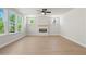 Bright living room with hardwood floors features an electric fireplace and plenty of natural light at 910 Melody Ridge Ln, Buford, GA 30518