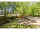 A secluded backyard with lush grass and mature trees, perfect for outdoor activities at 1055 Woodland Se Ave, Atlanta, GA 30316