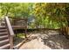 A spacious and private backyard featuring mature trees and a custom deck with stairs at 1055 Woodland Se Ave, Atlanta, GA 30316