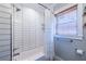 Well lit bathroom with a tiled shower and a window at 1055 Woodland Se Ave, Atlanta, GA 30316