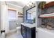 The renovated bathroom features decorative tiles, floating wood shelves, and a shower with a tub at 1055 Woodland Se Ave, Atlanta, GA 30316