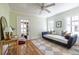 Cozy bedroom features a daybed, a ceiling fan, a neutral rug, and natural light at 1055 Woodland Se Ave, Atlanta, GA 30316