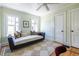 Comfortable bedroom features a daybed, two windows, and hardwood floors at 1055 Woodland Se Ave, Atlanta, GA 30316
