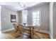 This dining room has hardwood floors, a unique light fixture, and comfortable seating at 1055 Woodland Se Ave, Atlanta, GA 30316
