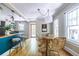 This dining room features hardwood floors, a decorative light fixture, and large windows at 1055 Woodland Se Ave, Atlanta, GA 30316