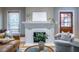 Elegant living room with a brick fireplace, built-in window seat, and hardwood floors at 1055 Woodland Se Ave, Atlanta, GA 30316