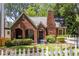 Charming brick home with a landscaped yard and a welcoming front porch and flower garden at 1055 Woodland Se Ave, Atlanta, GA 30316