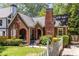 Charming brick home with a landscaped yard and a welcoming front porch and flower garden at 1055 Woodland Se Ave, Atlanta, GA 30316