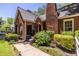Charming brick home with a landscaped yard, flower garden, and a welcoming front porch at 1055 Woodland Se Ave, Atlanta, GA 30316