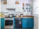 Updated kitchen with teal cabinets, butcher block countertops, and stainless appliances at 1055 Woodland Se Ave, Atlanta, GA 30316