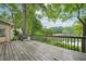 Spacious wooden deck with a beautiful view of the lake and trees at 177 Coopers Pond Dr, Lawrenceville, GA 30044