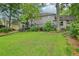 Spacious backyard showcases the home's outdoor living space with lush lawn and mature trees at 177 Coopers Pond Dr, Lawrenceville, GA 30044
