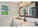 Bathroom with double vanity, granite countertops, and a large mirror at 177 Coopers Pond Dr, Lawrenceville, GA 30044