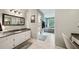 Bathroom featuring double vanities, granite countertops, walk-in shower, and soaking tub, offering spa-like experience at 177 Coopers Pond Dr, Lawrenceville, GA 30044