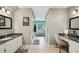 Bright bathroom with double vanities, granite countertops, and tiled floors, offering style and functionality at 177 Coopers Pond Dr, Lawrenceville, GA 30044