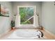 Bathroom features a luxurious soaking tub with a view of the outdoors, creating a serene and relaxing atmosphere at 177 Coopers Pond Dr, Lawrenceville, GA 30044