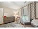 Comfortable Bedroom with dresser, area rug, and natural light from the window at 177 Coopers Pond Dr, Lawrenceville, GA 30044