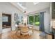 Sunlit dining area with modern table, chairs, and scenic view at 177 Coopers Pond Dr, Lawrenceville, GA 30044