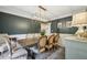 Elegant dining room with decorative lighting, neutral chairs, and dark accent wall perfect for entertaining at 177 Coopers Pond Dr, Lawrenceville, GA 30044