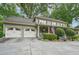Two-story home with attached garage and an inviting front porch, lush lawn and professional landscaping at 177 Coopers Pond Dr, Lawrenceville, GA 30044