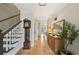 Inviting foyer with hardwood floors, staircase, and classic grandfather clock enhancing the home's charm at 177 Coopers Pond Dr, Lawrenceville, GA 30044
