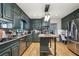 Well-appointed kitchen with stainless steel appliances, wood island, granite countertops, and stylish fixtures at 177 Coopers Pond Dr, Lawrenceville, GA 30044