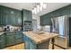 Updated kitchen featuring stainless steel appliances, kitchen island, and shaker style green cabinets at 177 Coopers Pond Dr, Lawrenceville, GA 30044