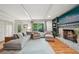 Inviting living room featuring a brick fireplace, plush seating, and natural light with a scenic view at 177 Coopers Pond Dr, Lawrenceville, GA 30044