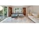 Open living room with large sofa, built-in shelves, tile floor, and expansive windows offering natural light at 177 Coopers Pond Dr, Lawrenceville, GA 30044