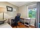 Well-lit home office featuring a spacious desk, ergonomic chair, and view of the outdoors, perfect for productivity at 177 Coopers Pond Dr, Lawrenceville, GA 30044
