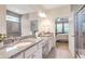 Bathroom with dual vanities, granite countertops and glass shower at 2920 Farmstead Way, Suwanee, GA 30024