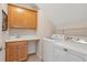Convenient laundry room with storage cabinets, sink and modern machines at 2920 Farmstead Way, Suwanee, GA 30024