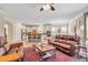 Spacious living room with wood floors opens to kitchen with stainless steel appliances at 2920 Farmstead Way, Suwanee, GA 30024